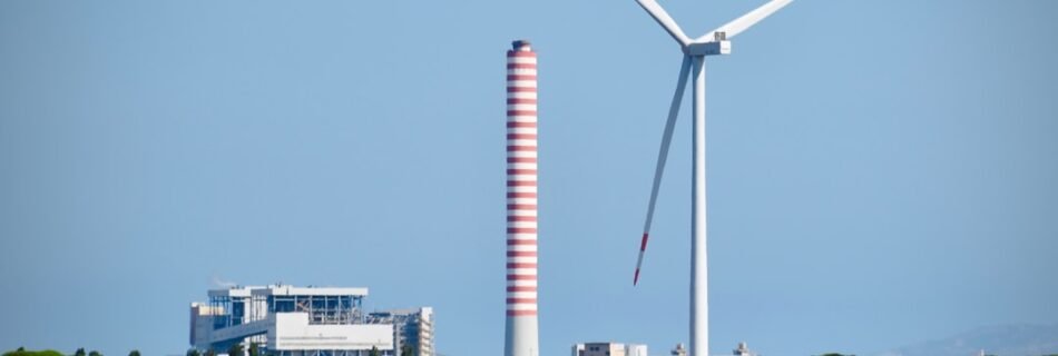 A wind farm with a wind turbine in the background