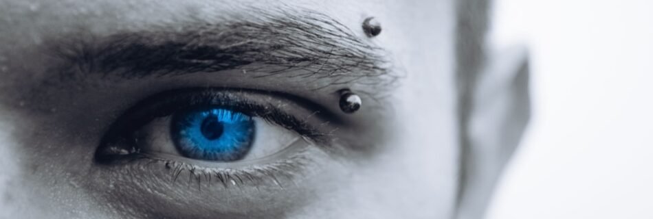 selective photo of man's blue eye