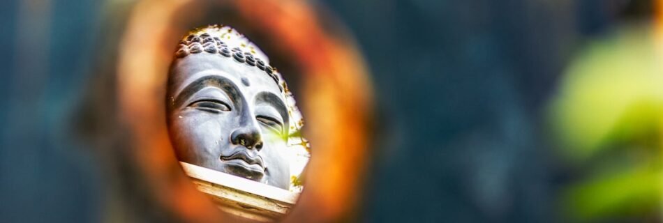 a buddha statue is seen through a circular hole